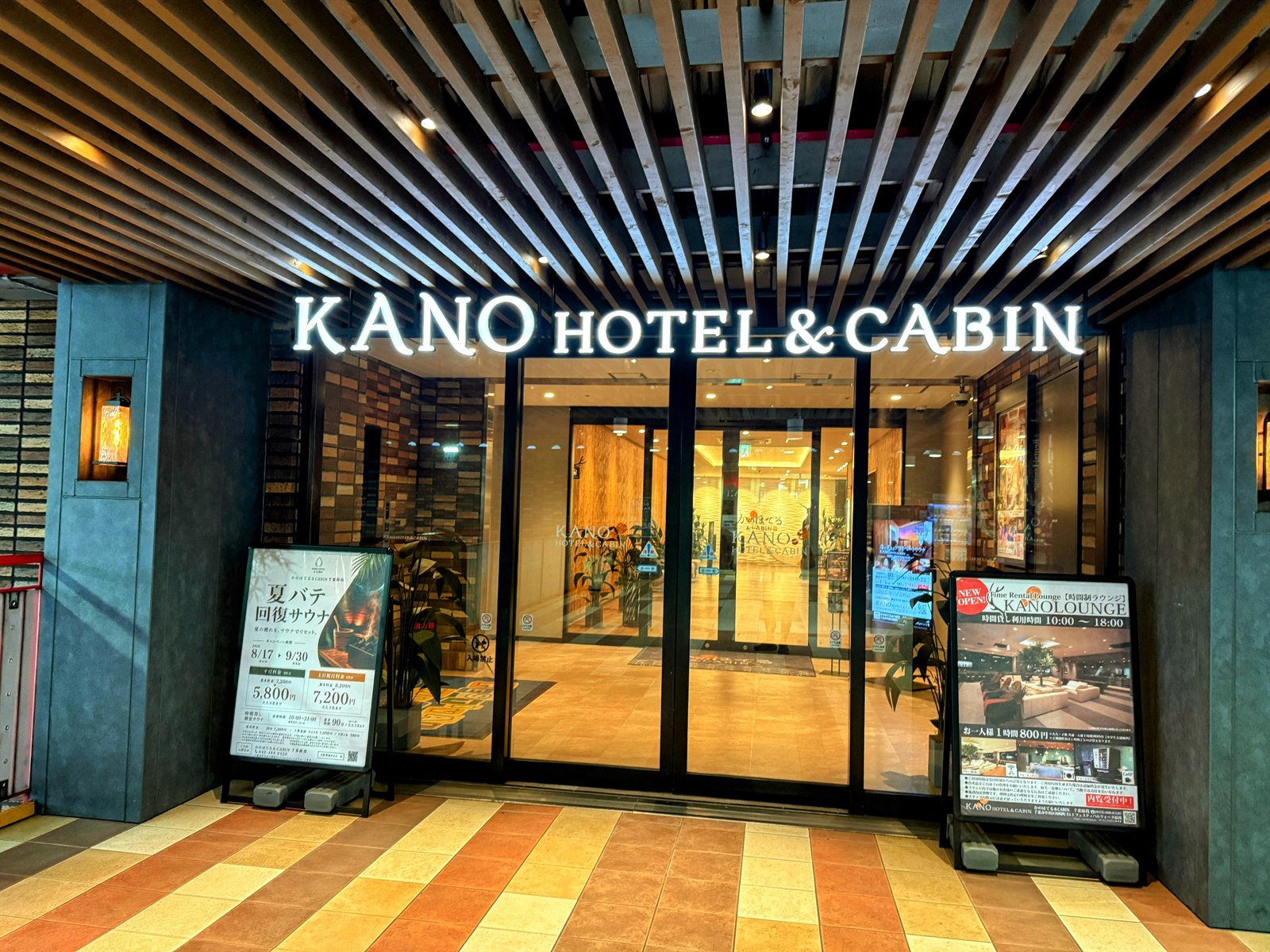 かのほてる＆キャビンのエントランス。KANO HOTEL & CABINの明るいサインと入口